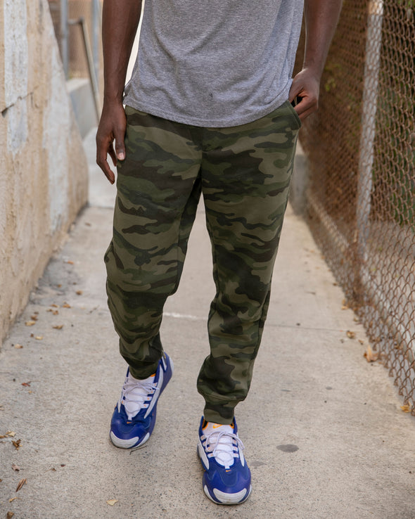 Close up of green camouflage sweatpants on a male model.